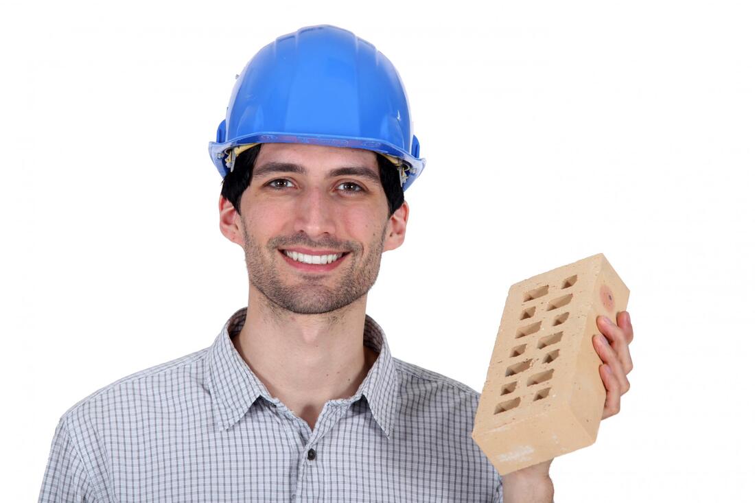 handyman holding a concrete bricks